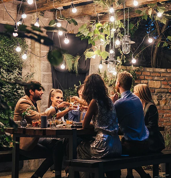 Friends Raising Glasses At Outdoor Dinner Party